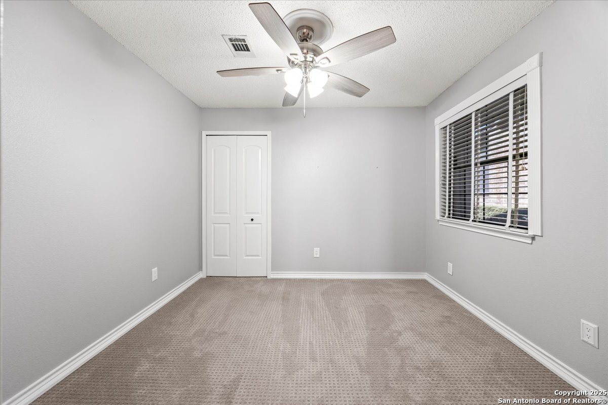 9308 Dover Ridge San Antonio, TX 78250 - Photo 8 of 41 a view of an empty room with a window