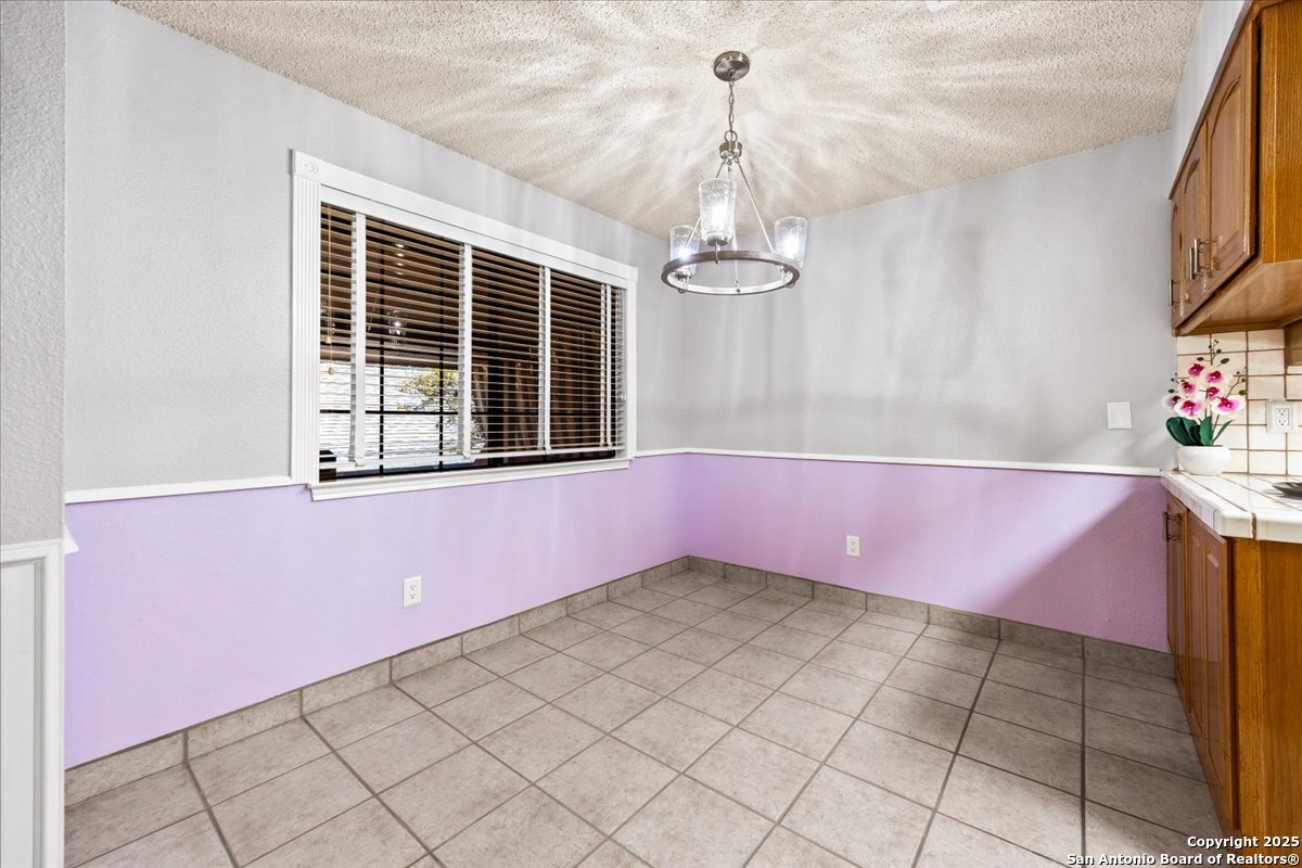 9308 Dover Ridge San Antonio, TX 78250 - Photo 9 of 41 a view of an empty room with a window