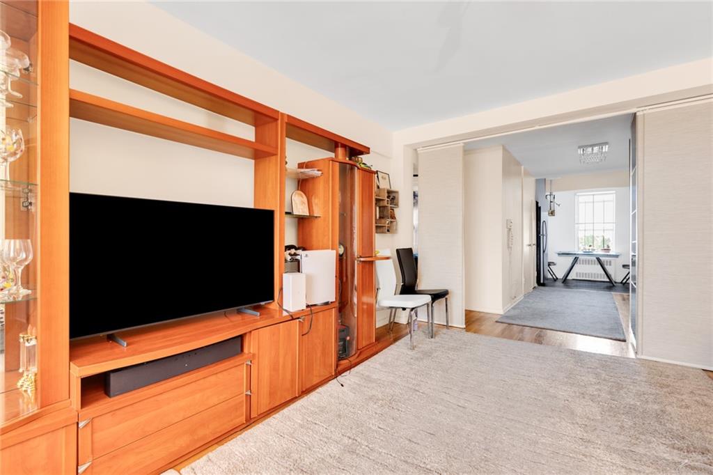2155 82nd Street, Unit 5D Brooklyn, NY 11214 - Photo 11 of 19 a living room with furniture and a flat screen tv