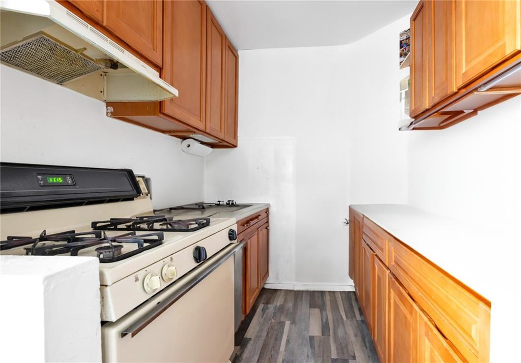 2155 82nd Street, Unit 5D Brooklyn, NY 11214 - Photo 15 of 19 a kitchen with stainless steel appliances granite countertop a stove and a microwave