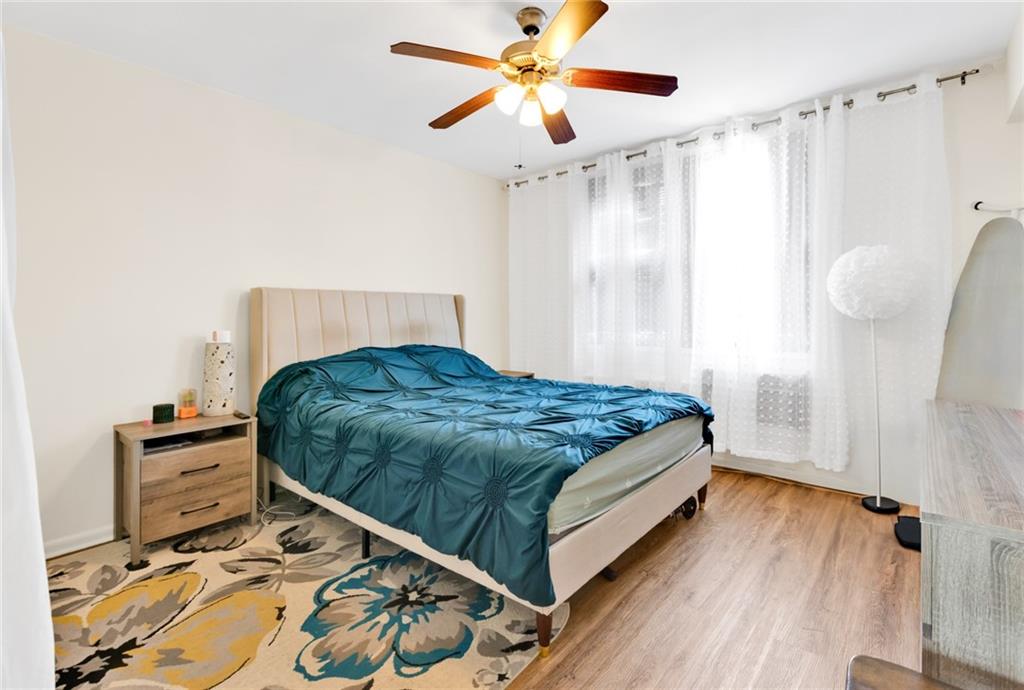 2155 82nd Street, Unit 5D Brooklyn, NY 11214 - Photo 3 of 19 a bedroom with a bed and a chandelier