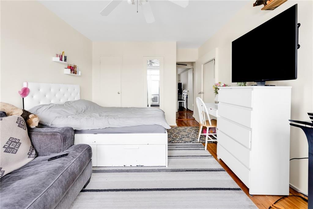 2155 82nd Street, Unit 5D Brooklyn, NY 11214 - Photo 5 of 19 a living room with a flat screen tv and a couch