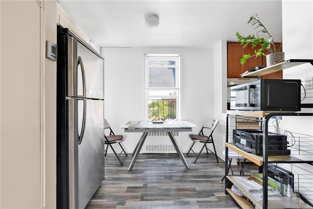 2155 82nd Street, Unit 5D Brooklyn, NY 11214 - Photo 7 of 19 a view of a livingroom with furniture flat screen tv and wooden floor