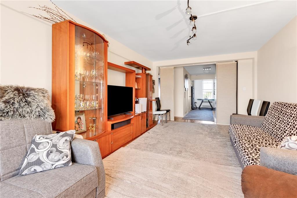 2155 82nd Street, Unit 5D Brooklyn, NY 11214 - Photo 10 of 19 a living room with furniture and a flat screen tv
