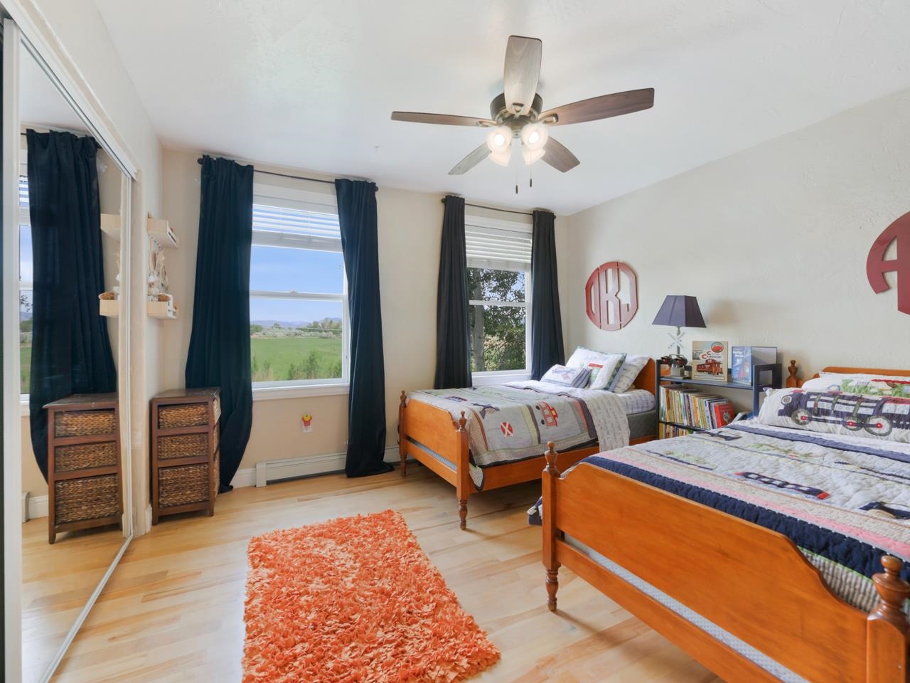 2433 H Road Grand Junction, CO 81505 - Photo 27 of 42 a bedroom with two beds and a chandelier