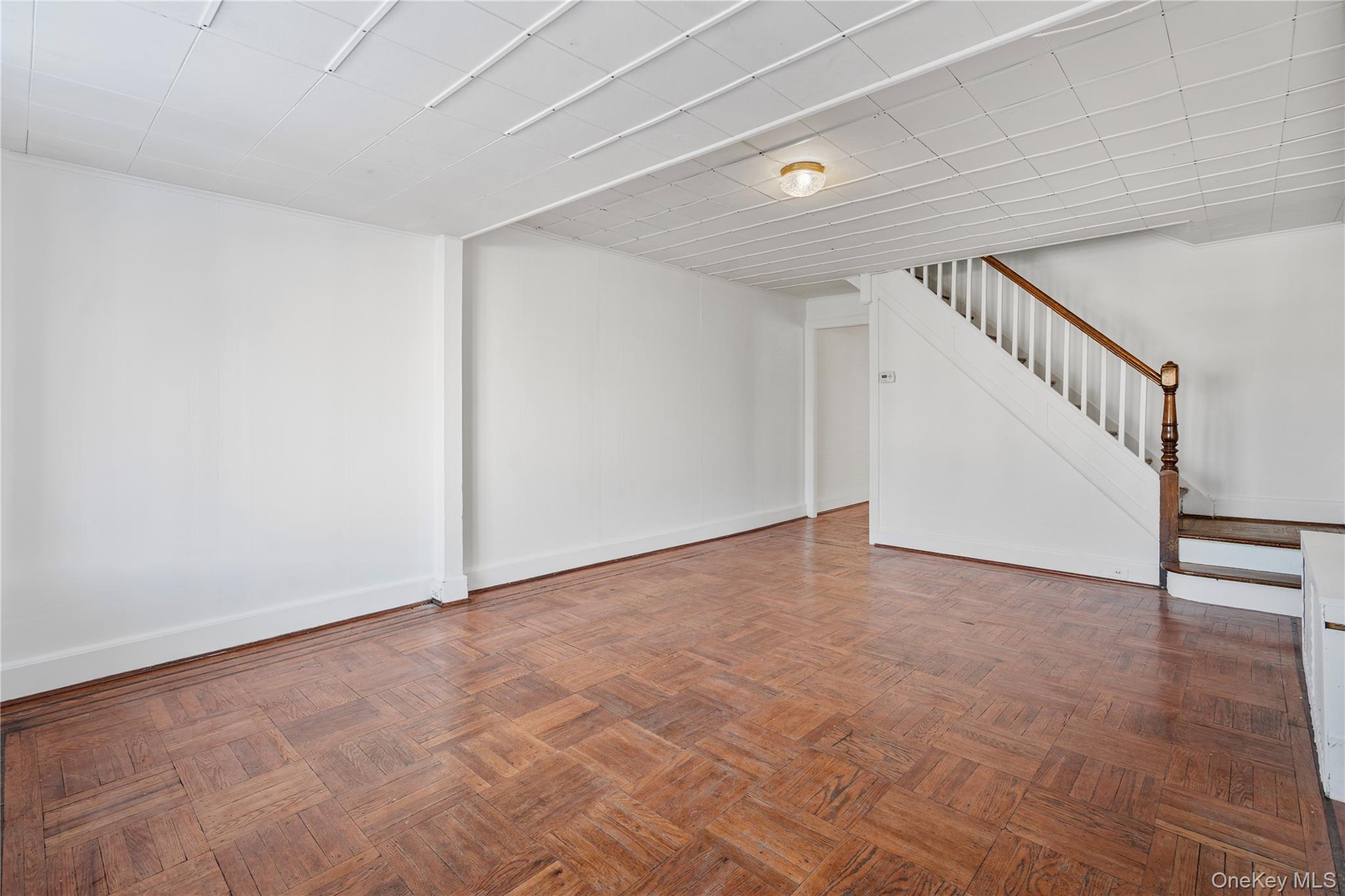 123-10 25th Road Queens, NY 11354 - Photo 12 of 27 Finished below grade area with stairway and parquet floors
