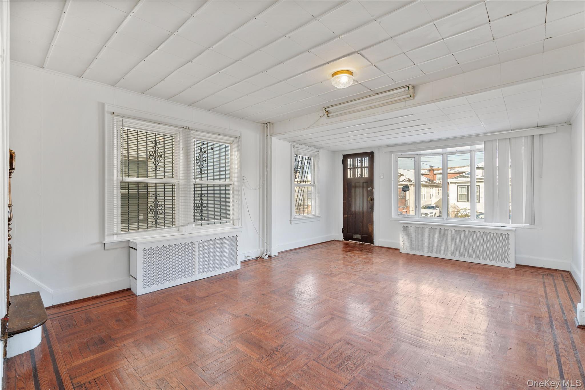 123-10 25th Road Queens, NY 11354 - Photo 13 of 27 Foyer entrance with radiator and parquet floors
