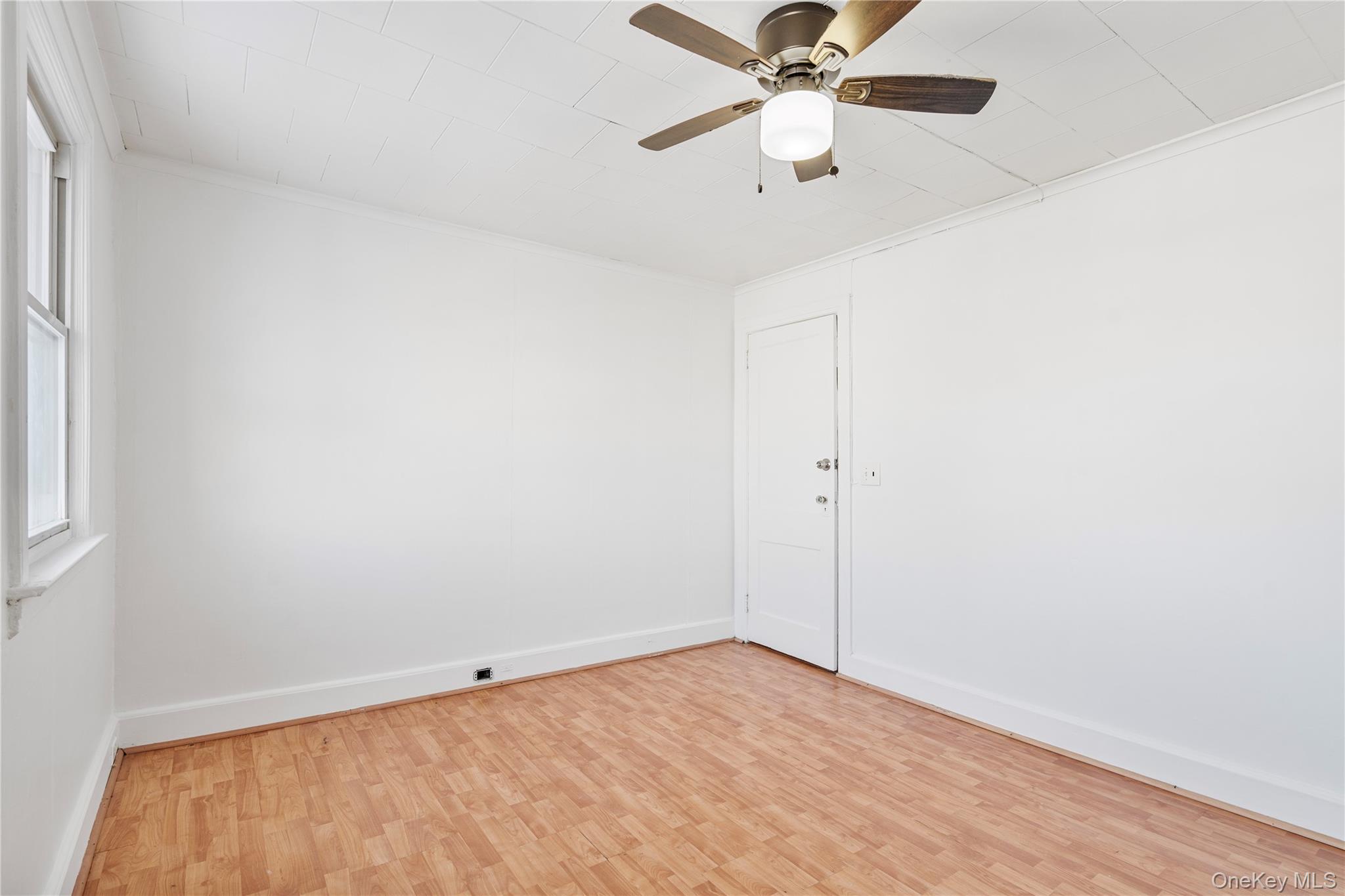 123-10 25th Road Queens, NY 11354 - Photo 16 of 27 Empty room featuring light wood-type flooring, ceiling fan, and ornamental molding