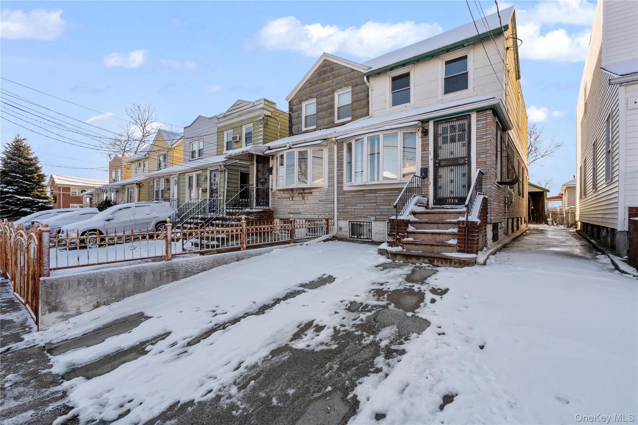 123-10 25th Road Queens, NY 11354 - Photo 2 of 27 View of front of home featuring stone siding and a residential view