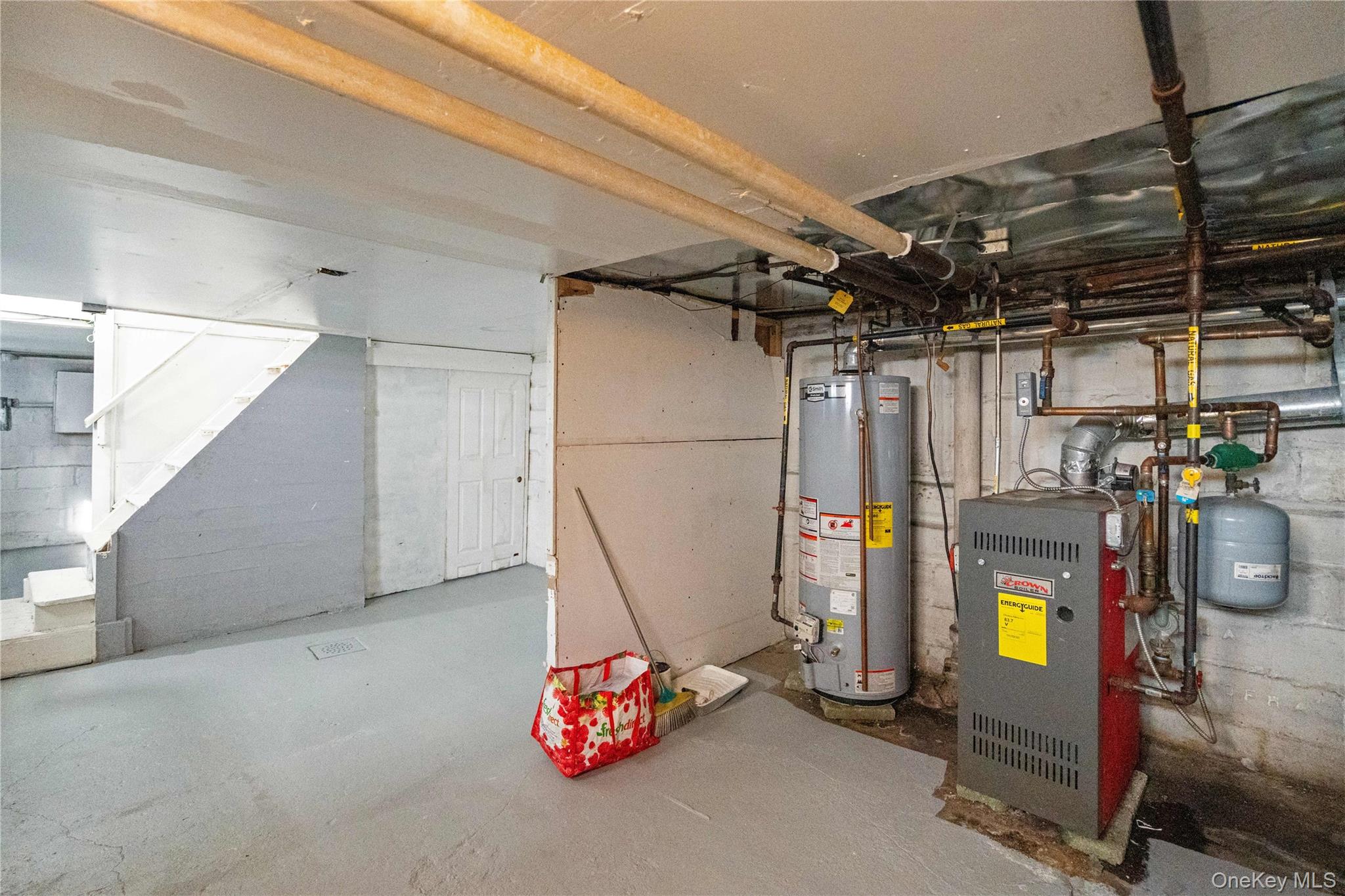 123-10 25th Road Queens, NY 11354 - Photo 23 of 27 Unfinished basement with gas water heater and a heating unit