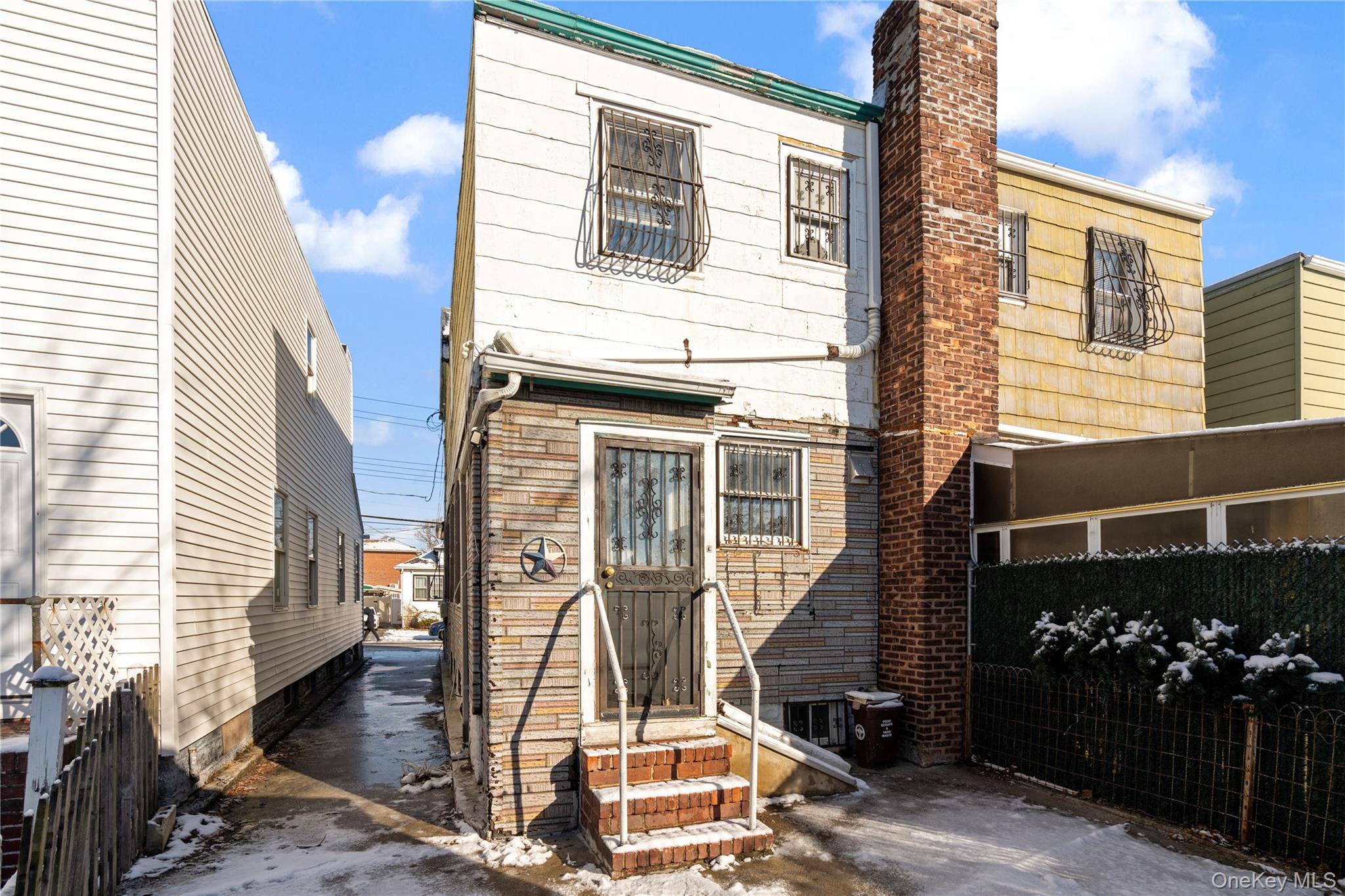 123-10 25th Road Queens, NY 11354 - Photo 25 of 27 View of front of property featuring a chimney