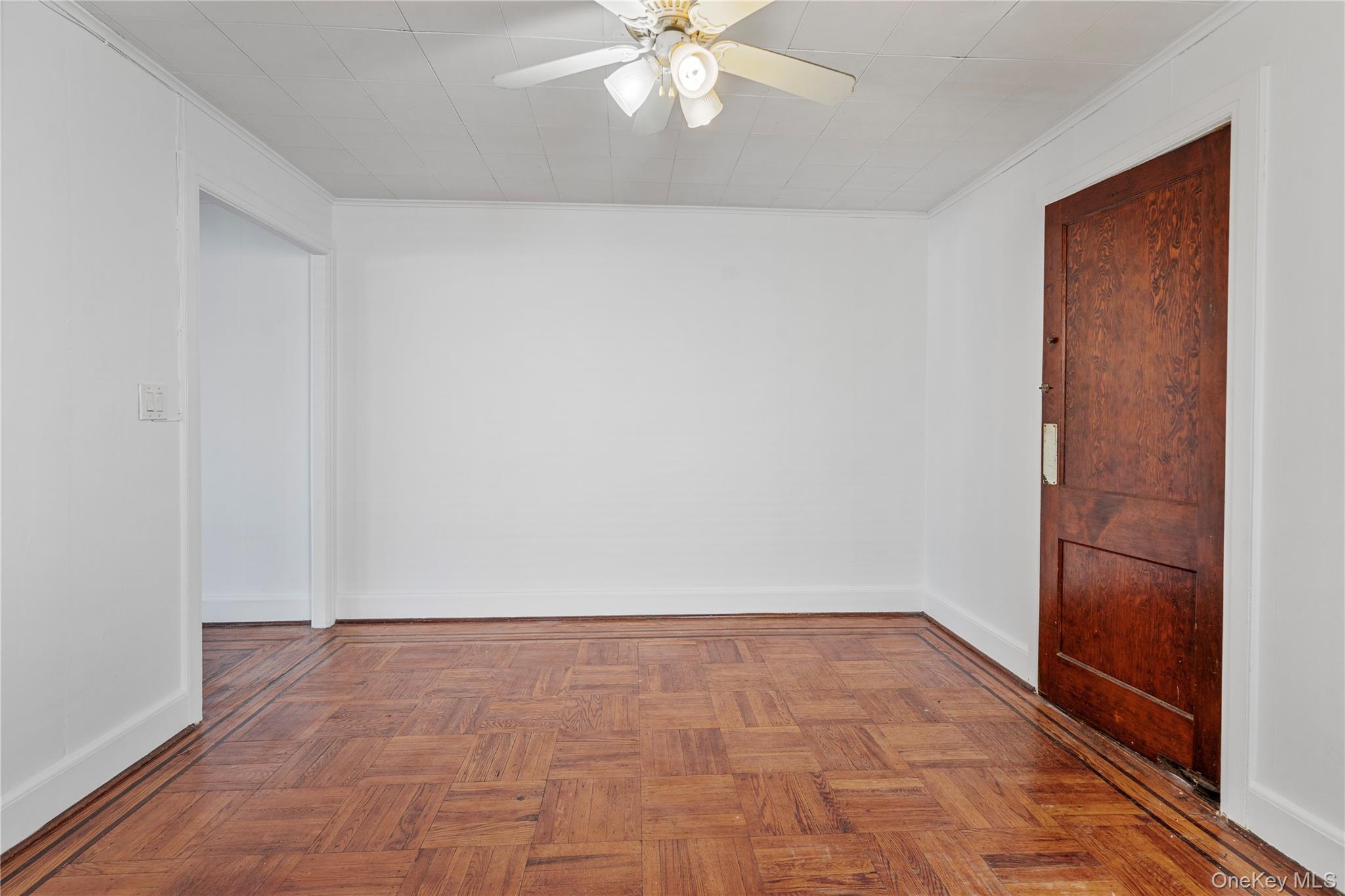 123-10 25th Road Queens, NY 11354 - Photo 9 of 27 Empty room featuring a ceiling fan, parquet floors, and crown molding