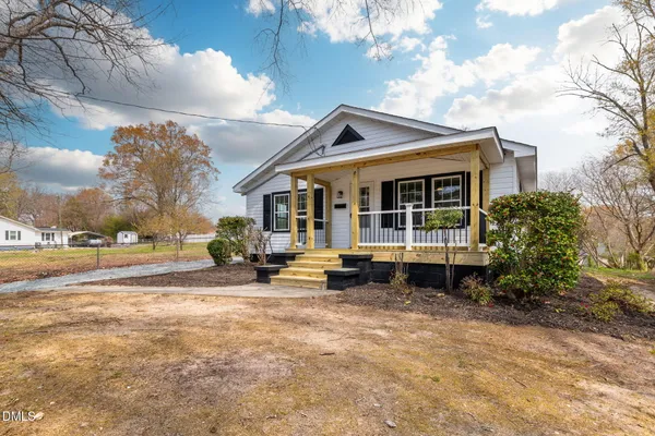 a view of swimming pool with outdoor seating and a yard