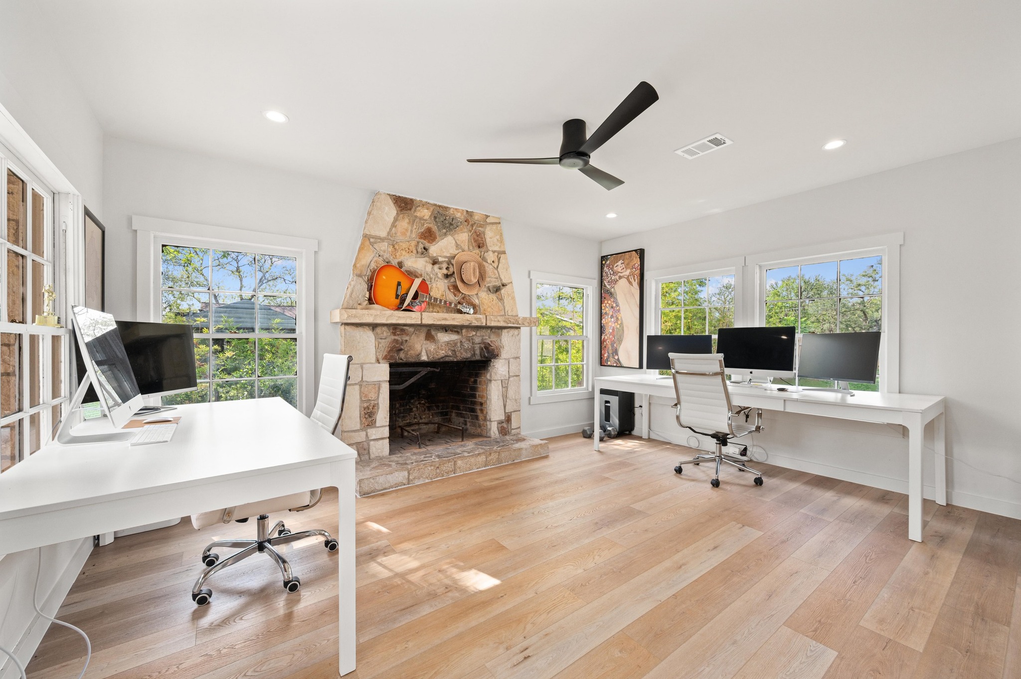 3501 Pecan Springs Road Austin, TX 78723 - Photo 18 of 40 Office featuring light wood-style floors, a stone fireplace, a ceiling fan, and recessed lighting