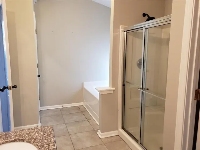 a bathroom with a shower and a sink