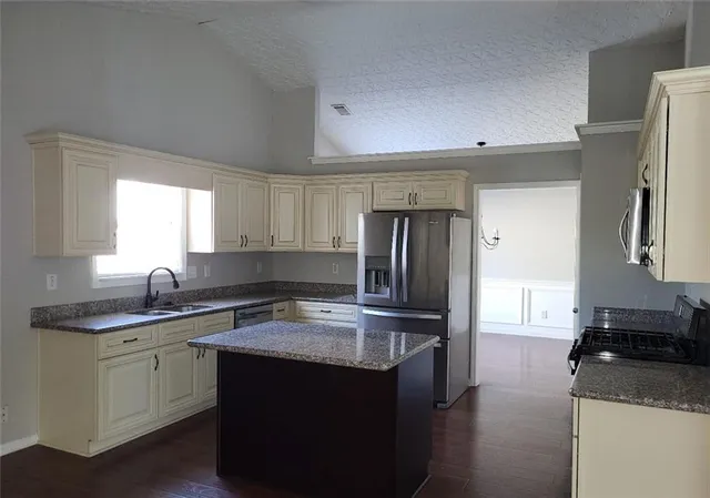 a kitchen with a sink stove and refrigerator