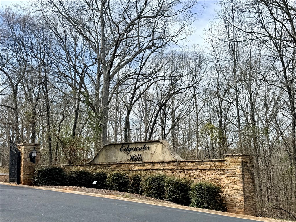 0 Overlook Drive Fair Play, SC 29643 - Photo 5 of 10 This grand entrance features a stone wall and gated access, welcoming you to the community.