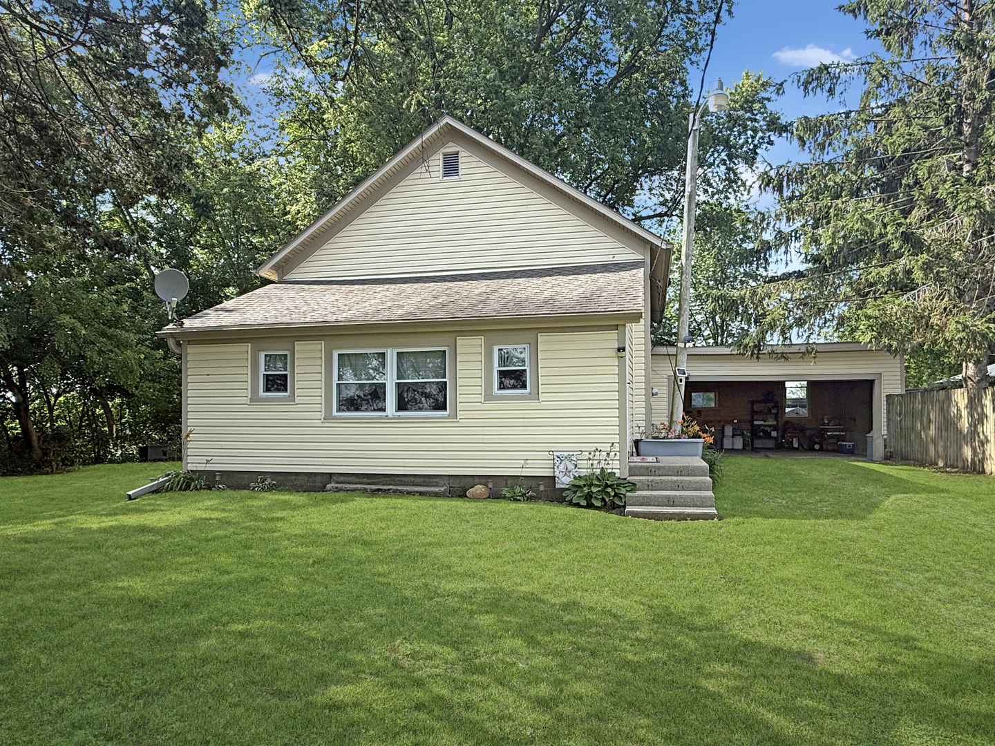 5843 West Stephenson St Road Freeport, IL 61032 - Photo 1 of 30 a front view of house with yard and trees in the background