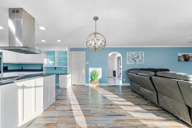 a kitchen with stainless steel appliances granite countertop a refrigerator sink and stove