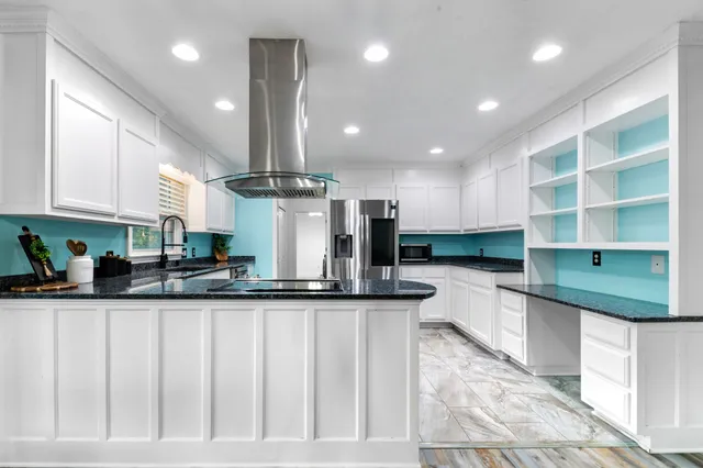 a kitchen with stainless steel appliances granite countertop a sink and cabinets