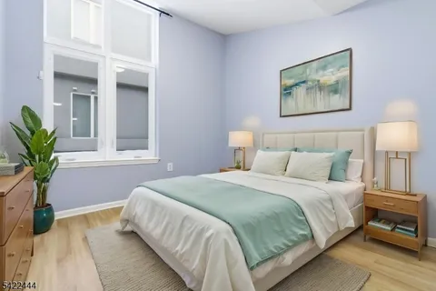 a bedroom with a bed and a potted plant
