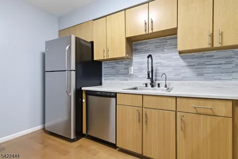 a kitchen with stainless steel appliances a refrigerator and a sink