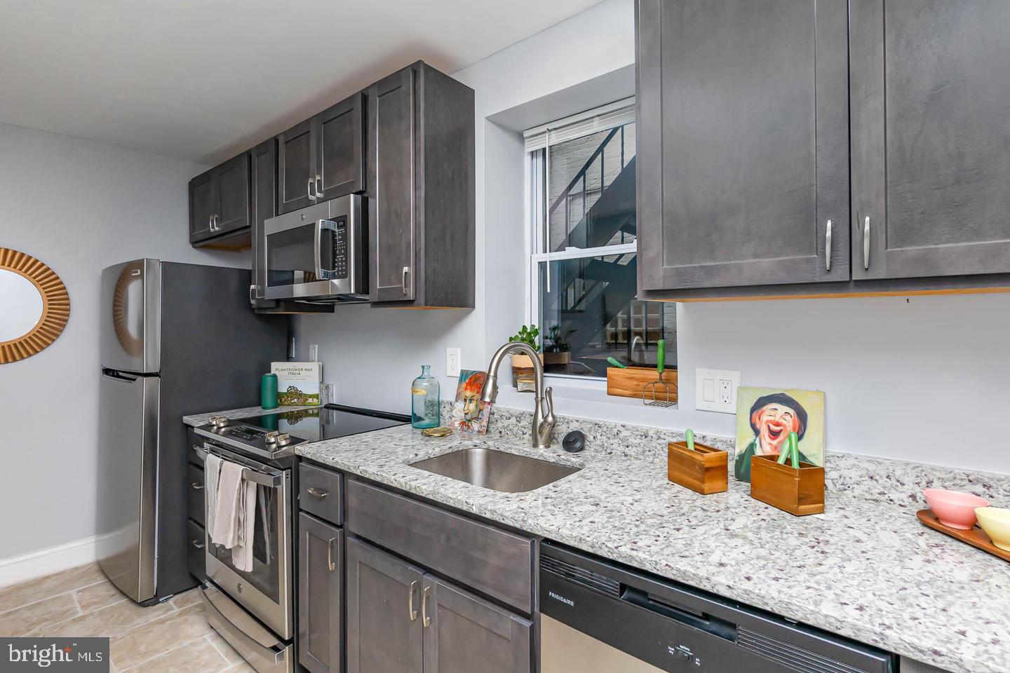 1709 Bank Street Baltimore, MD 21231 - Photo 15 of 49 a kitchen with stainless steel appliances granite countertop a sink stove and cabinets