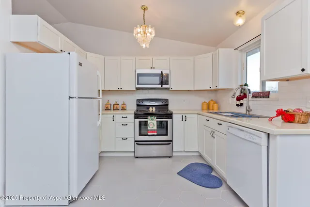 a kitchen with stainless steel appliances a refrigerator sink and cabinets