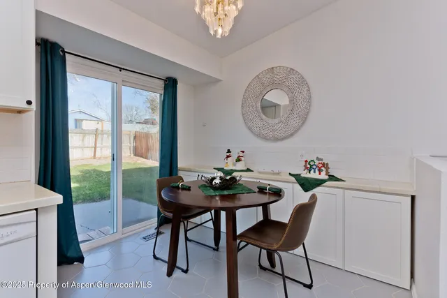 a view of a dining room with furniture and a chandelier