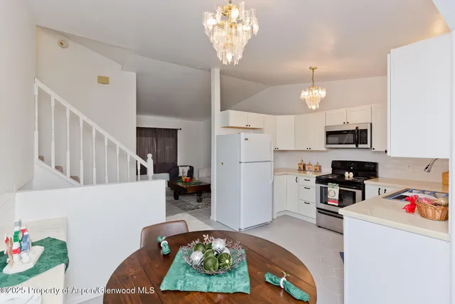 a kitchen with stainless steel appliances granite countertop a refrigerator sink and stove