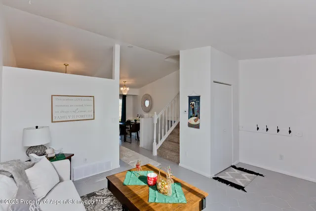 a living room with furniture and a rug