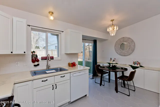 a kitchen with a sink cabinets and window