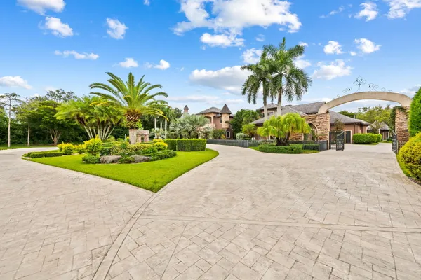 a front view of a house with a garden and yard