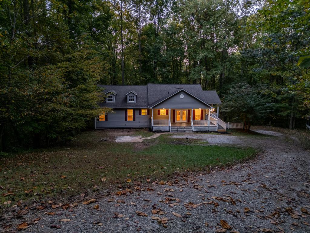 a backyard of a house with lots of green space and fountain