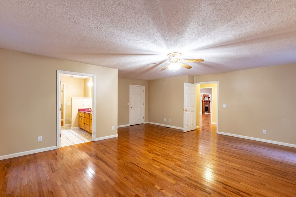 7 Spring Road Blairsville, GA 30512 - Photo 16 of 56 a view of an empty room with wooden floor and a window