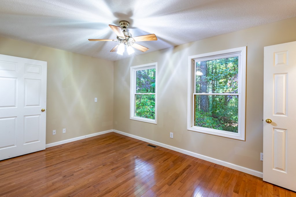 7 Spring Road Blairsville, GA 30512 - Photo 23 of 56 a view of an empty room with wooden floor and a window