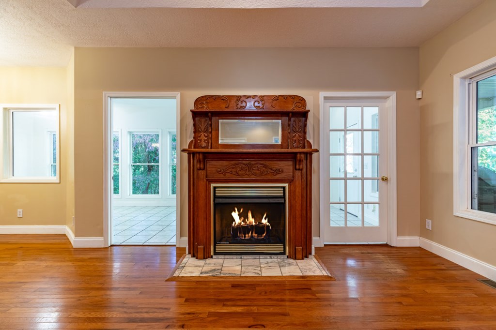 7 Spring Road Blairsville, GA 30512 - Photo 6 of 56 a living room with a fireplace and wooden floor