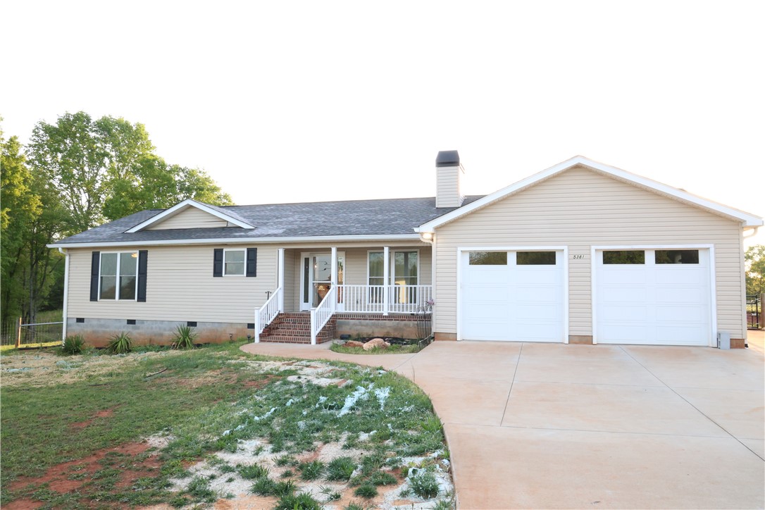 This charming home offers a welcoming facade with a convenient attached garage.