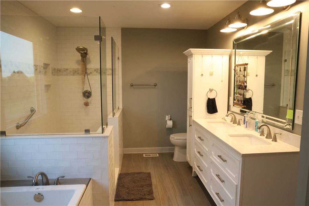 5381 Olden Porter Road Pendleton, SC 29670 - Photo 19 of 31 This serene bathroom offers a luxurious walk-in shower and elegant double vanity with ample storage.