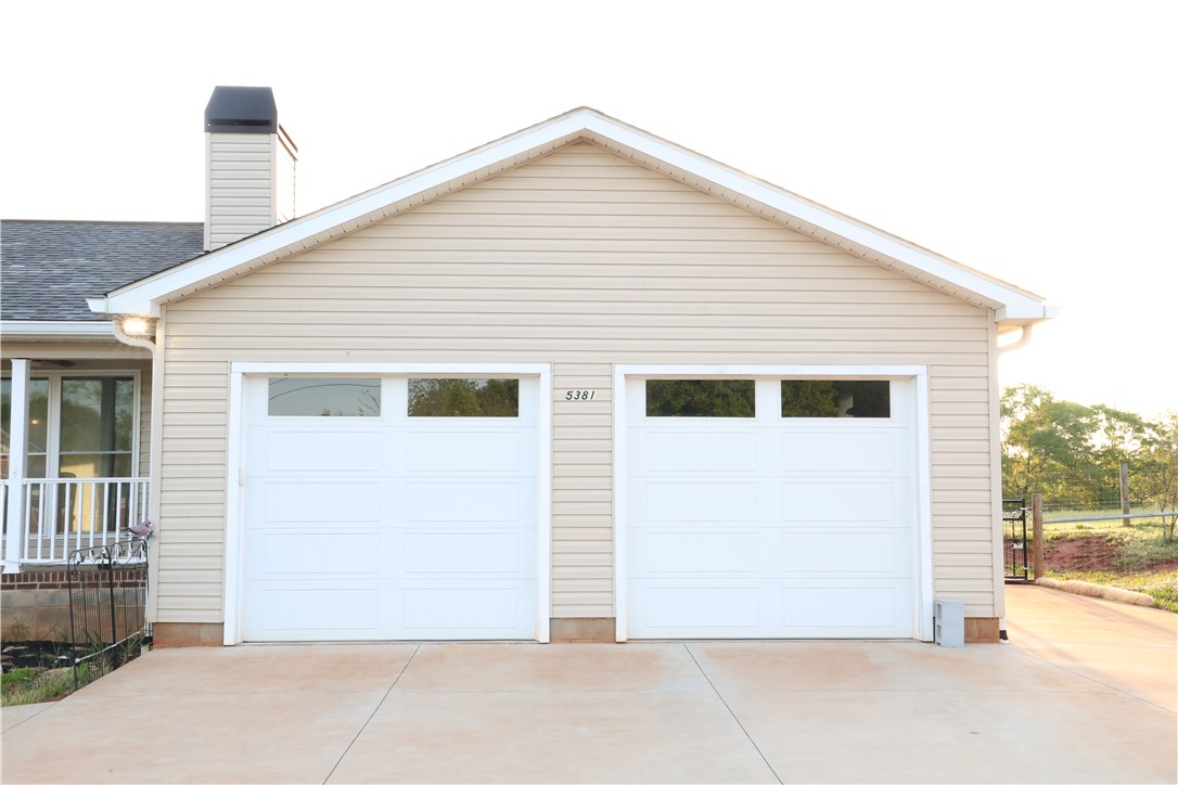 5381 Olden Porter Road Pendleton, SC 29670 - Photo 3 of 31 This residence features an attached garage with two white doors, offering convenient parking and storage.