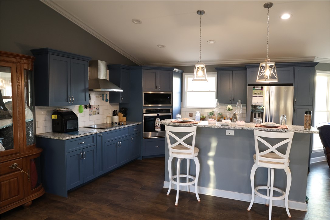 5381 Olden Porter Road Pendleton, SC 29670 - Photo 31 of 31 This kitchen showcases a central island with sleek countertops, perfect for culinary endeavors and gatherings.