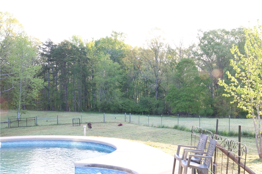 5381 Olden Porter Road Pendleton, SC 29670 - Photo 7 of 31 Enjoy outdoor living with a private pool and expansive views of lush greenery.