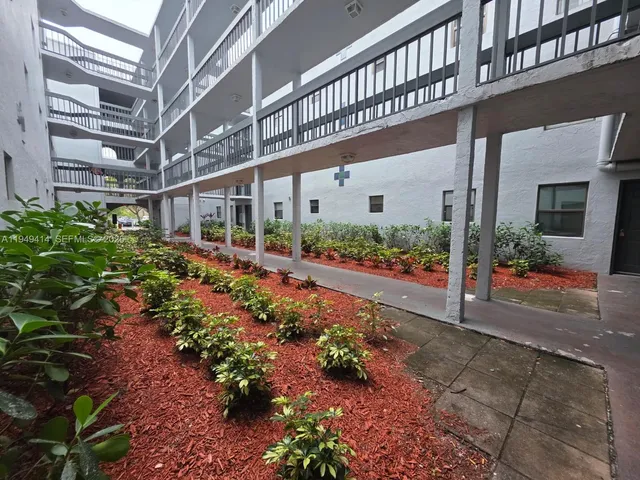 a view of a large building with potted plants