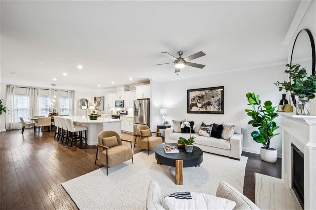 a living room with furniture potted plant and a table