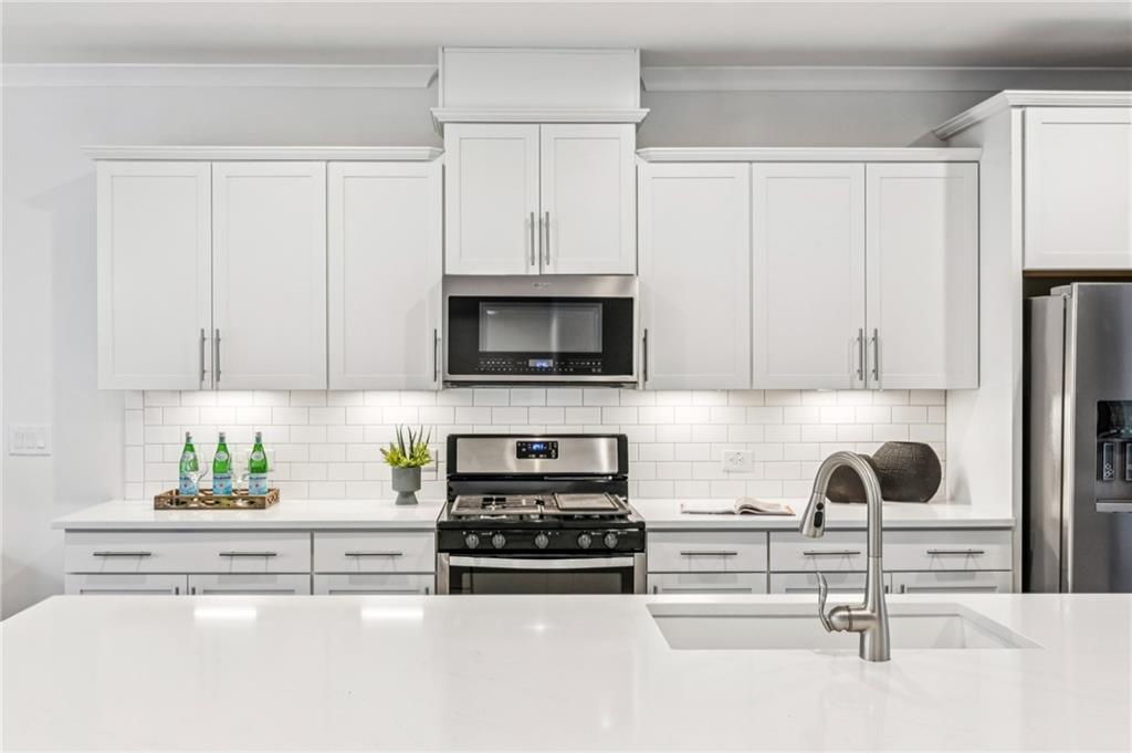 1155 Millennium Park Road Decatur, GA 30033 - Photo 25 of 81 a kitchen with white cabinets and appliances