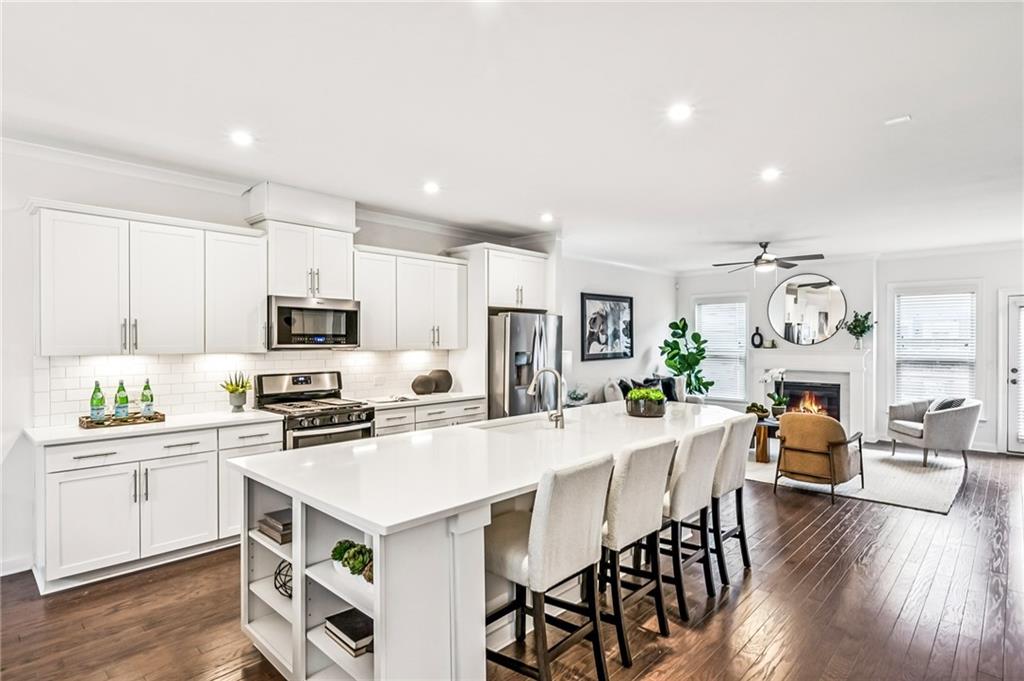 1155 Millennium Park Road Decatur, GA 30033 - Photo 28 of 81 a kitchen with white cabinets and stainless steel appliances