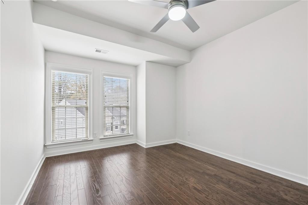 1155 Millennium Park Road Decatur, GA 30033 - Photo 46 of 81 an empty room with wooden floor and windows