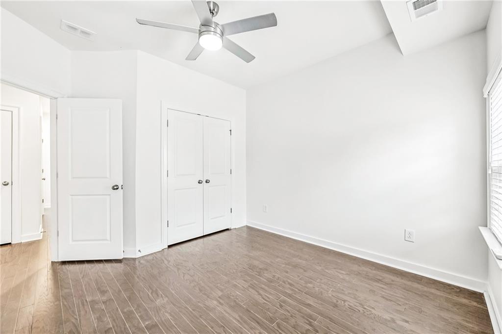 1155 Millennium Park Road Decatur, GA 30033 - Photo 50 of 81 an empty room with wooden floor ceiling fan and window