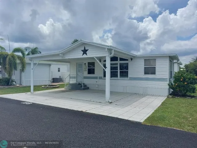 a view of a house with a yard and garage