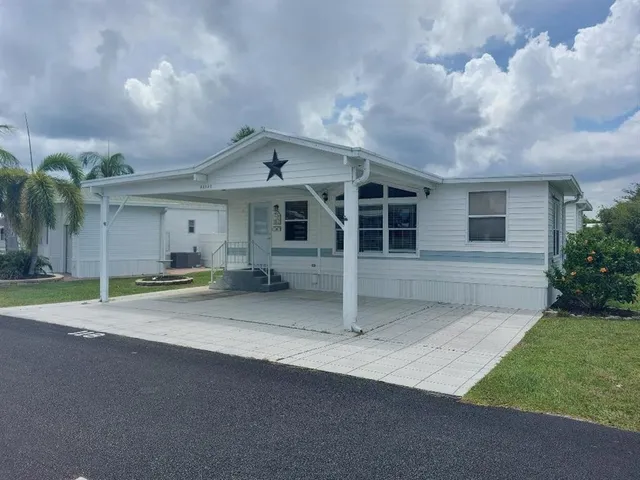 a view of a house with a yard and garage